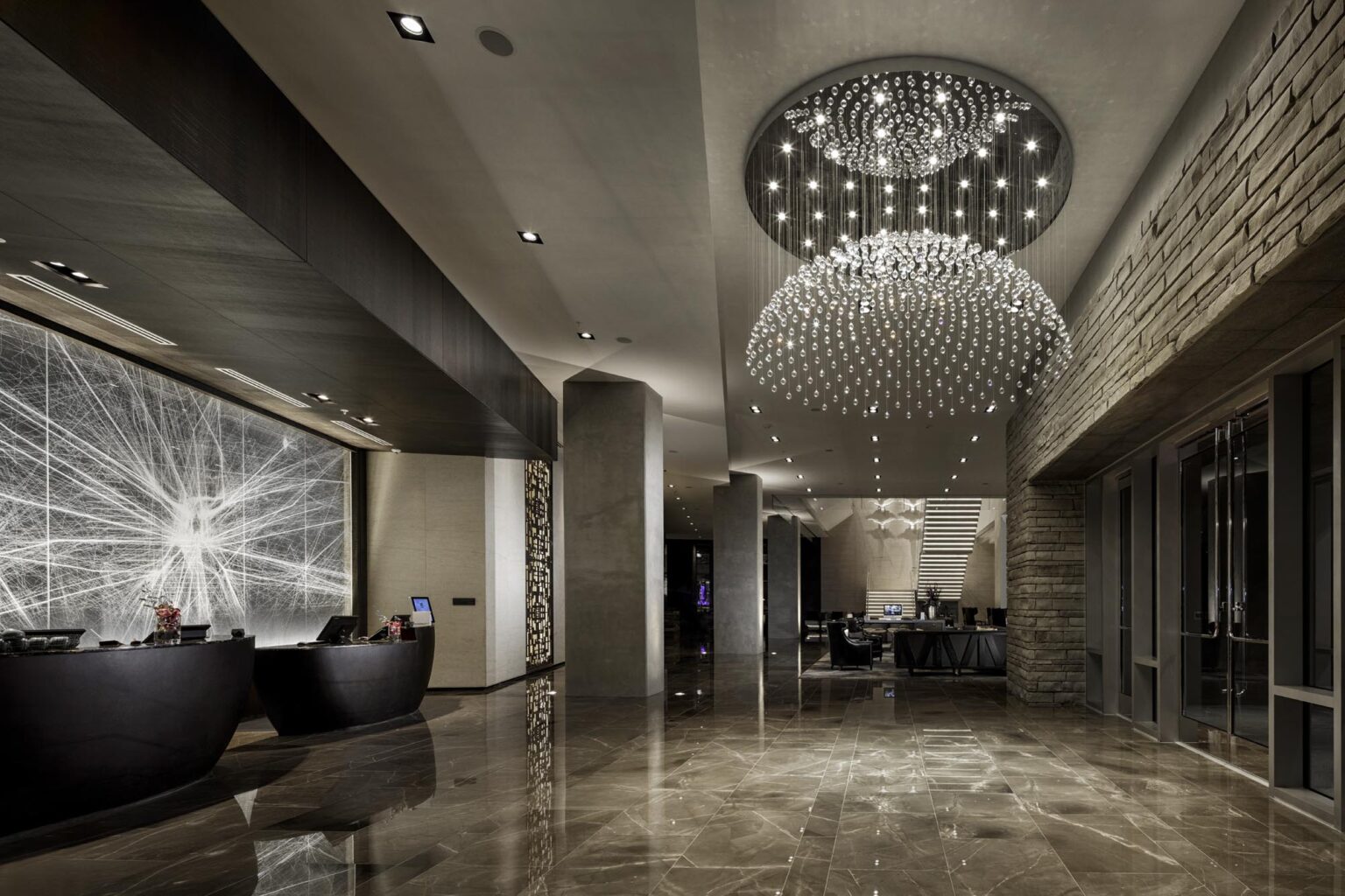 Luxury Hotel Lobby entrance and front desk with modern design brown tile floors and big chandelier