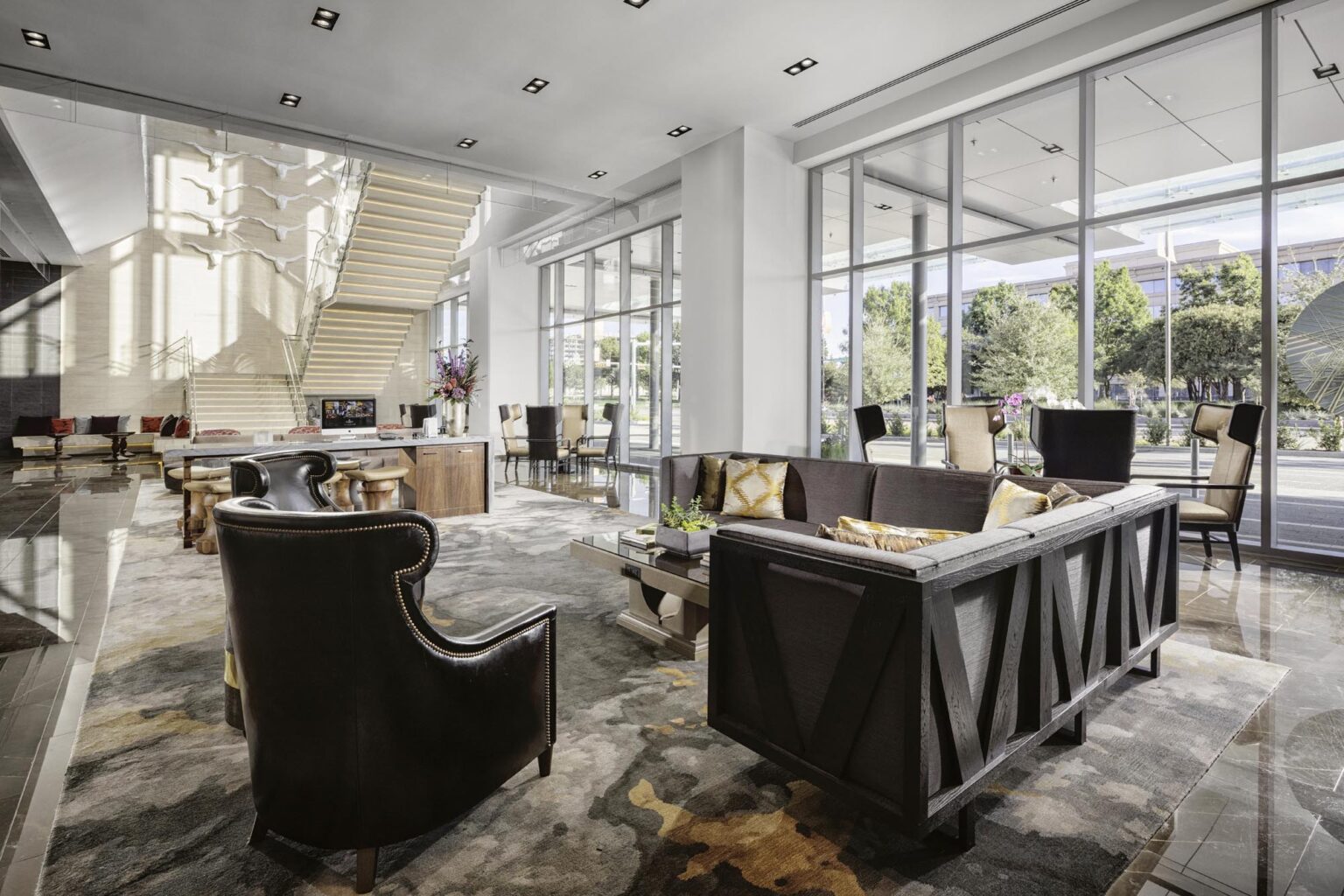 Hotel Lobby with modern sitting area, big windows, and natural light