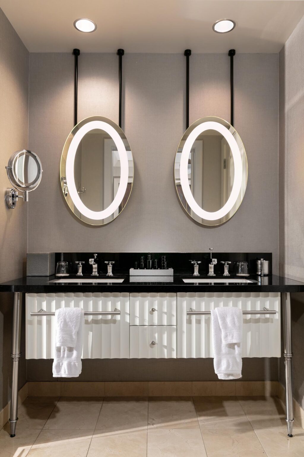 The Cosmopolitan of Las Vegas Master Bathroom has a Modern Black and White vanity and dual mirrors