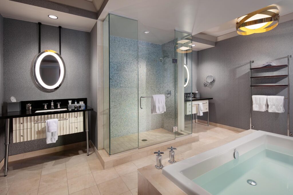 The Cosmopolitan of Las Vegas Wraparound suite master bathroom with a tub, a walking shower, and dual vanities