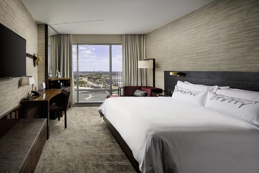 Modern, Clean Hotel Room interior with beige design elements and red couch